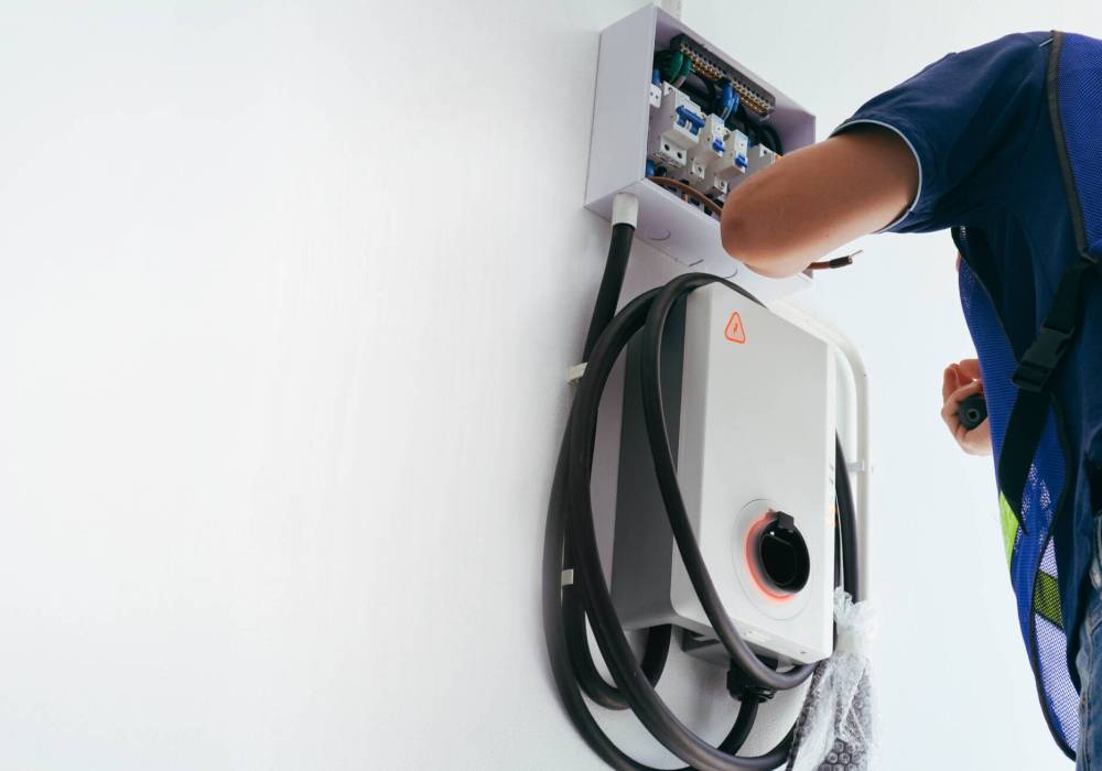 Certified male Electrician Installing Home EV Charger